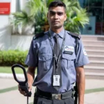 security guard holding a metal detector