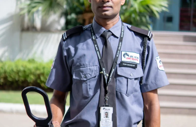 security guard holding a metal detector