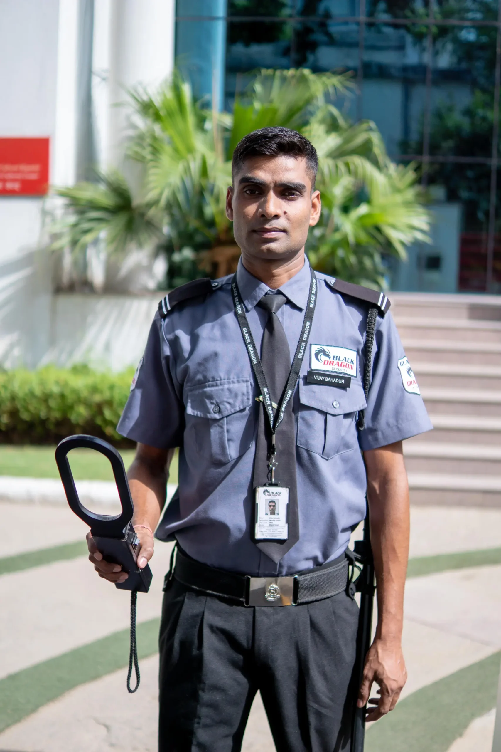 security guard holding a metal detector
